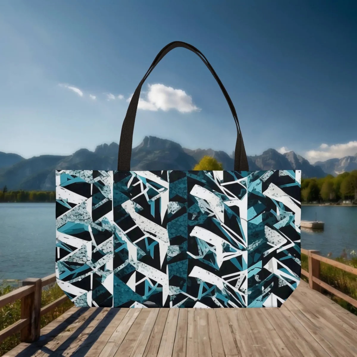 Flat view of a weekender tote bag with geometric triangle pattern in teal, black, and white