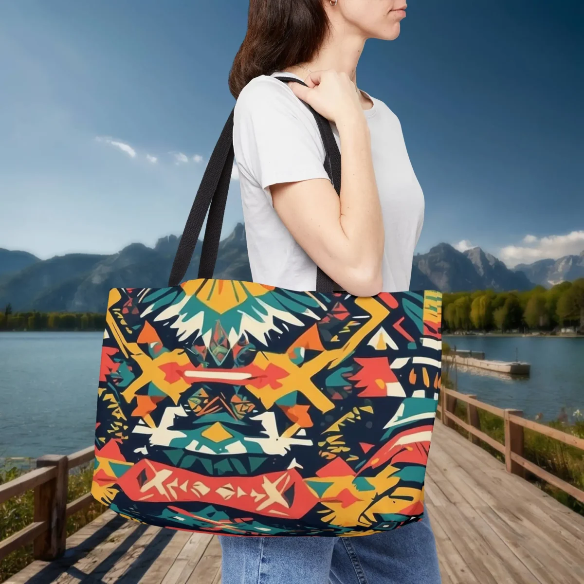 Woman wearing a weekender tote bag with bold and colorful Aztec pattern