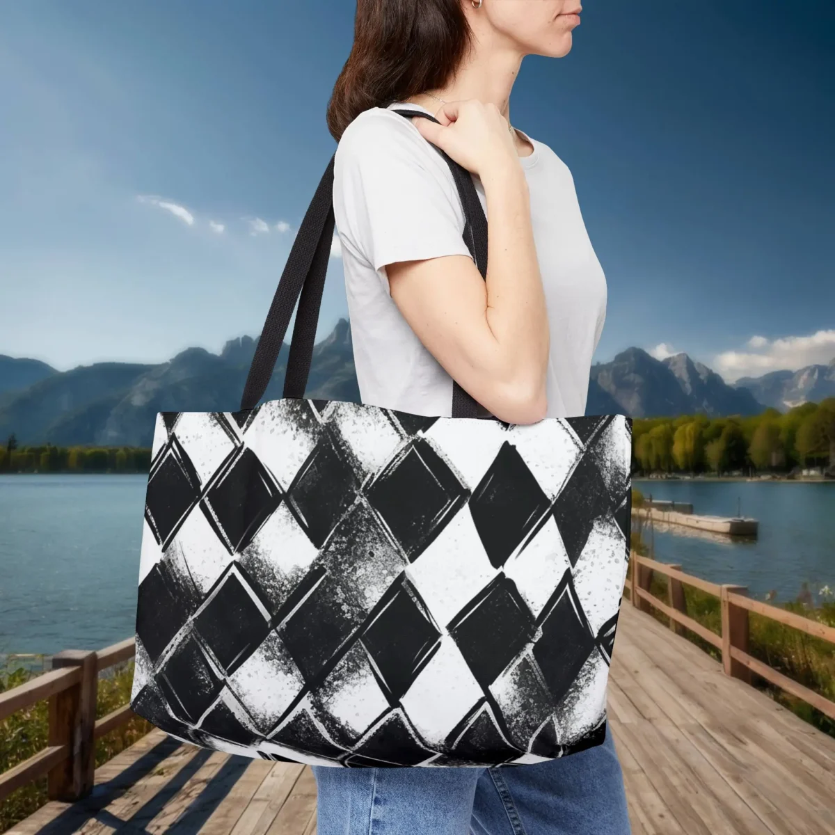 Woman wearing a weekender tote bag with a black and white checkered print