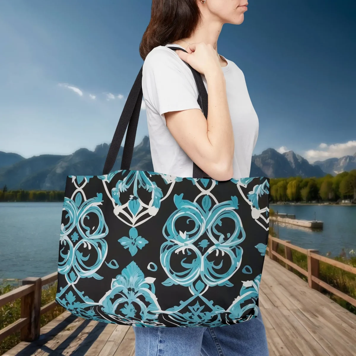 Woman carrying a black weekender tote bag with blue Moroccan trellis print