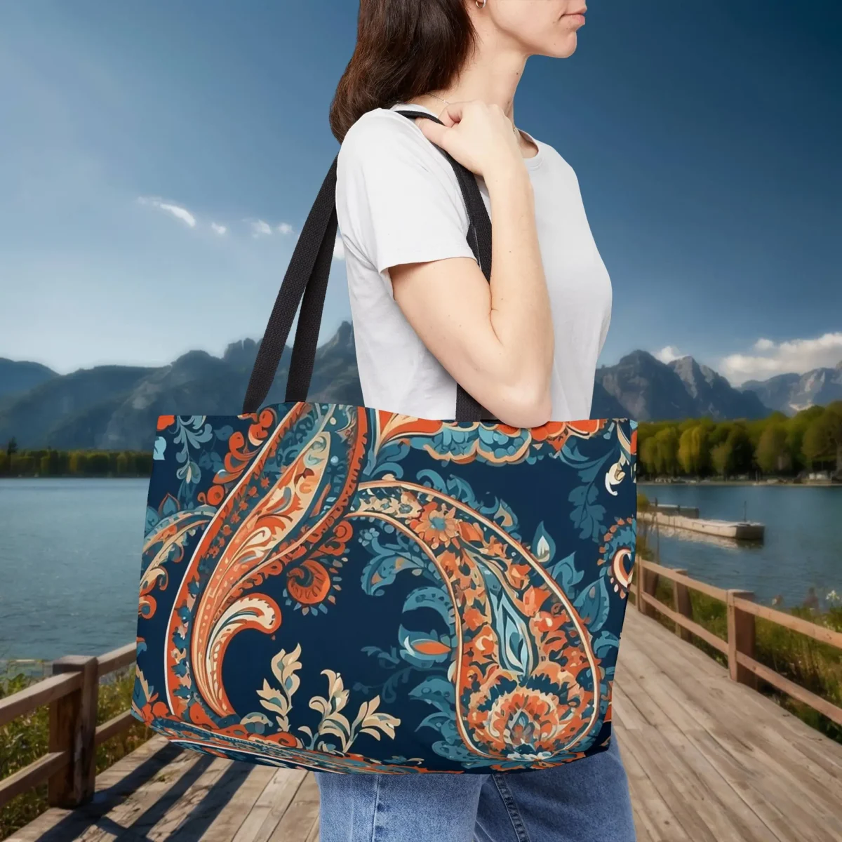 Woman carrying a paisley print weekender tote bag in vibrant colors
