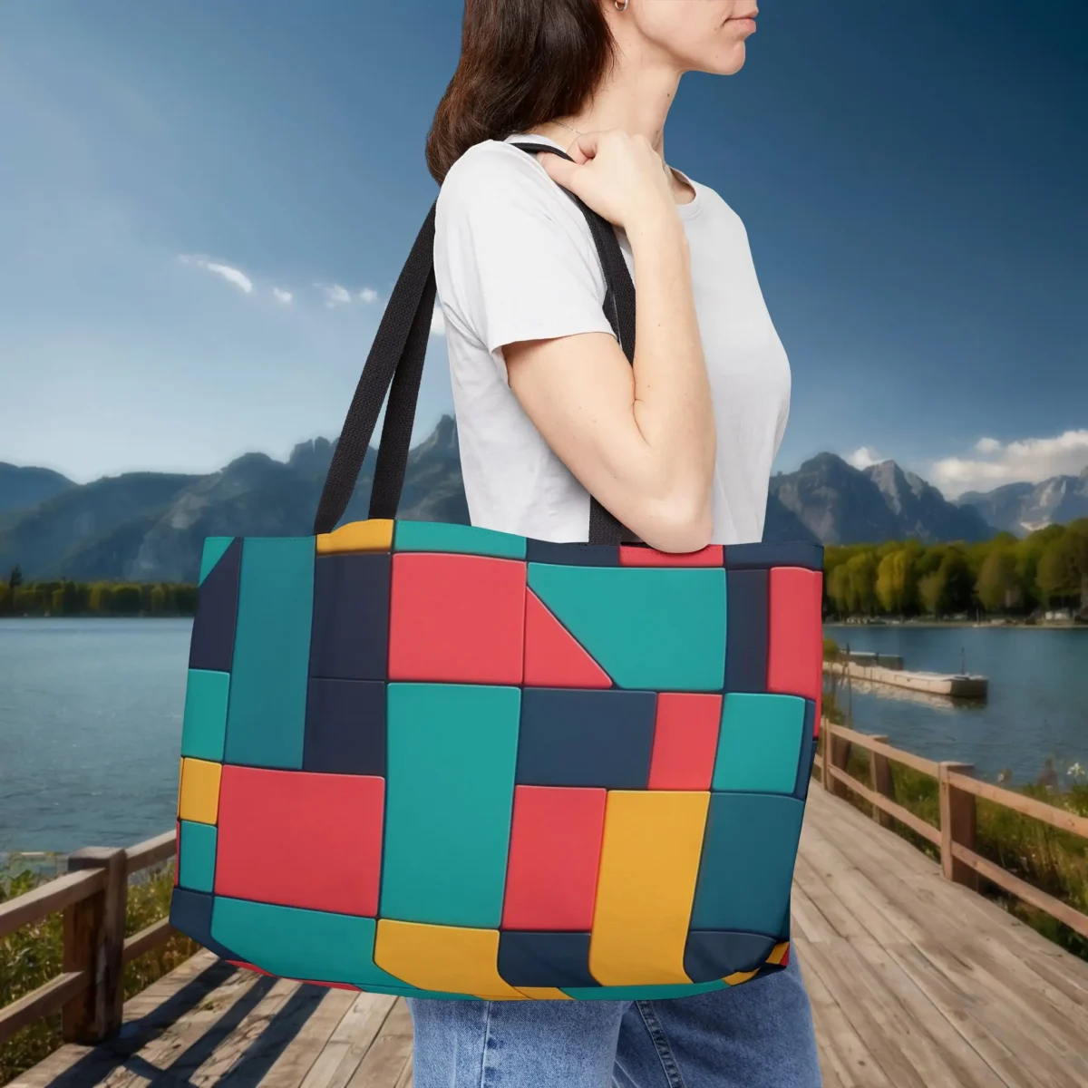 Woman carrying a multicolor weekender tote bag with geometric block pattern