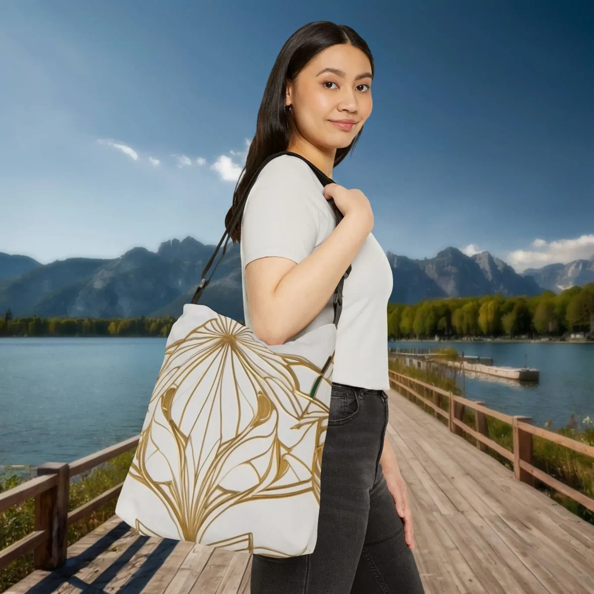 Woman wearing a gold line art tote bag over shoulder, styled with a simple white top and black jeans