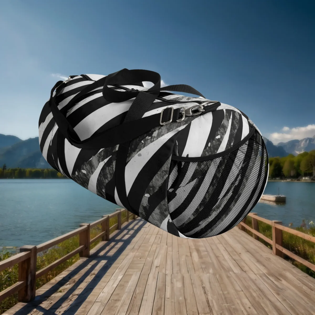 Large black and white striped duffel bag showing side mesh pocket and strap details, floating over a dock.