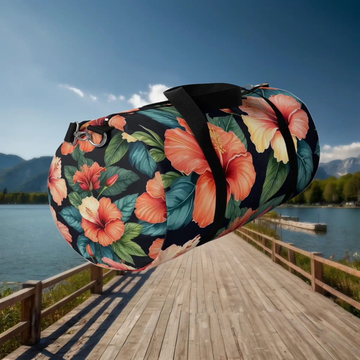 Large duffel bag with orange hibiscus flower print floating above a dock by the lake.