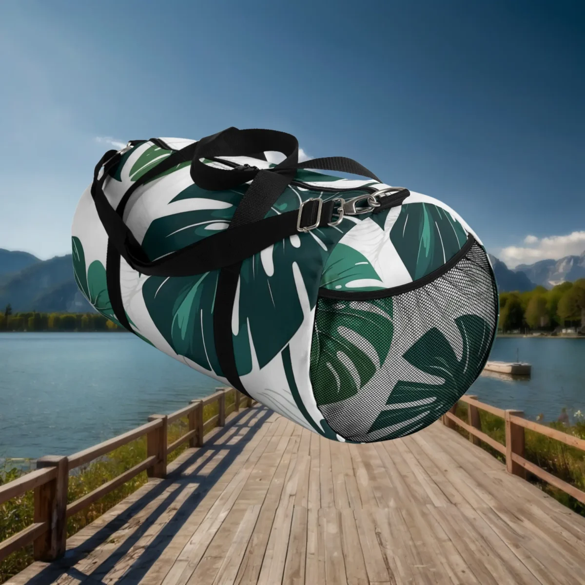 Side view of large monstera leaf duffel bag with black mesh pocket and shoulder strap.