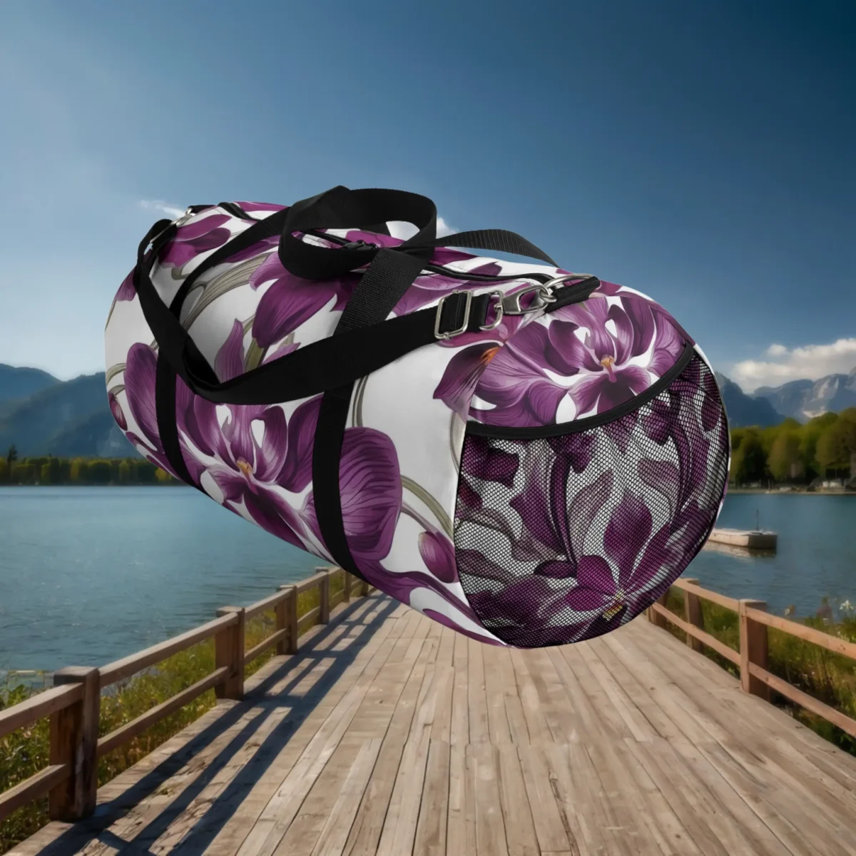 Side view of large duffel bag with purple orchid flowers and mesh pocket on a white background.