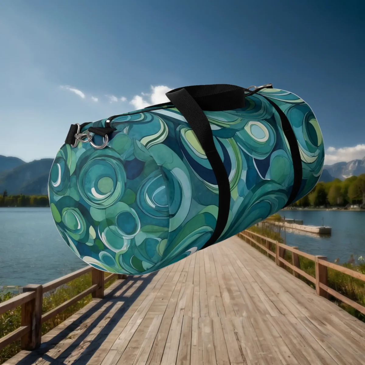 Angled floating view of large duffel bag with abstract green and blue circle pattern.
