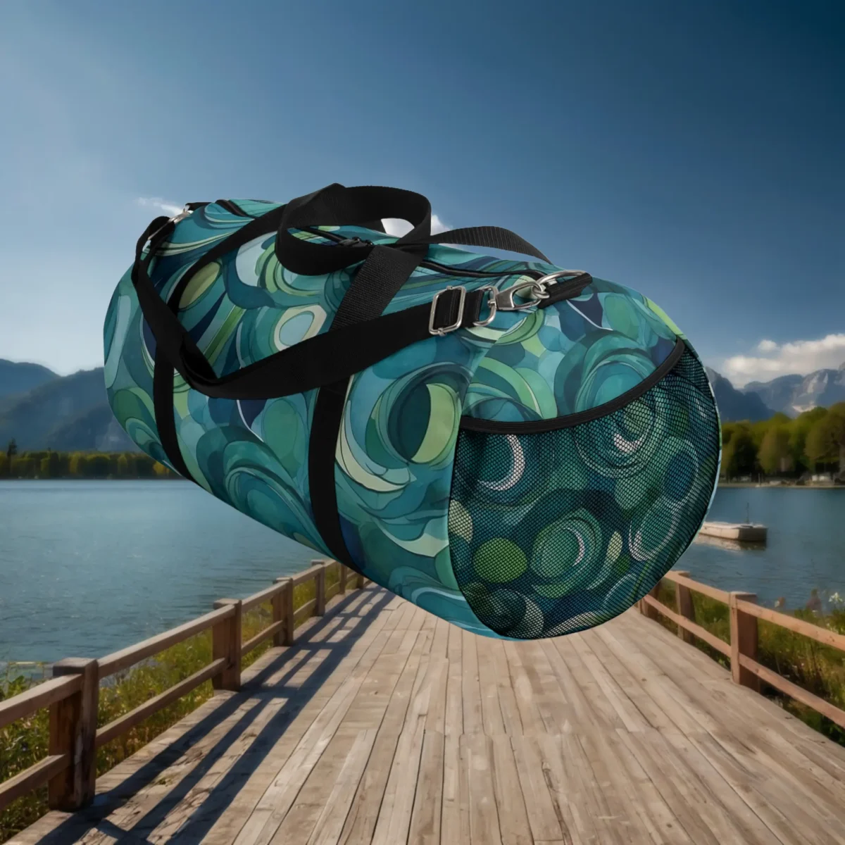 Side view of large duffel bag with abstract circular print and mesh pocket in blue and green tones.