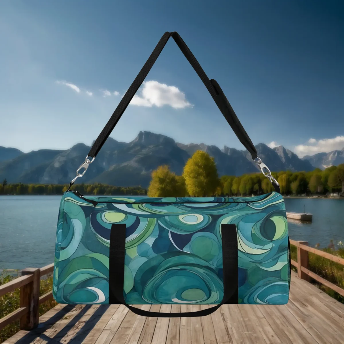 Front view of a large duffel bag featuring layered circular patterns in green, blue, and teal tones.