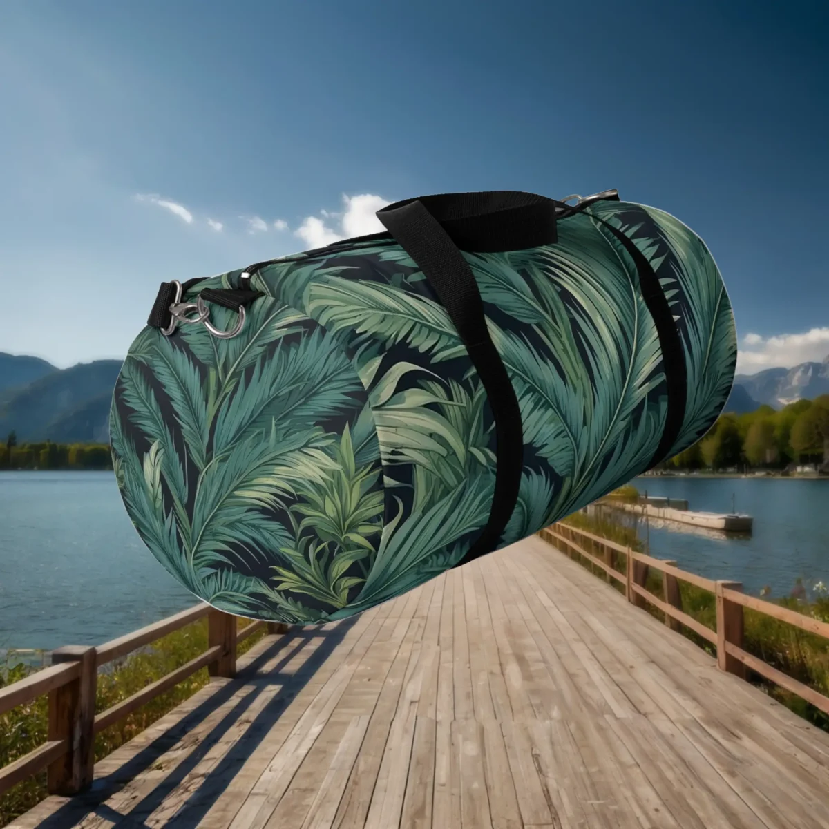 Floating side view of a large duffel bag with tropical palm leaf design in green on black.