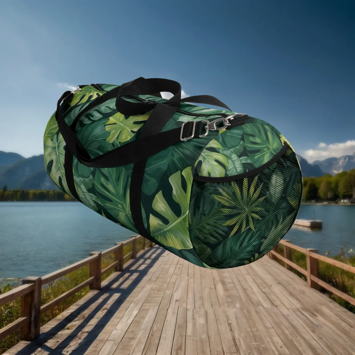 Side mesh pocket view of large duffel bag with tropical leaf print in green tones.