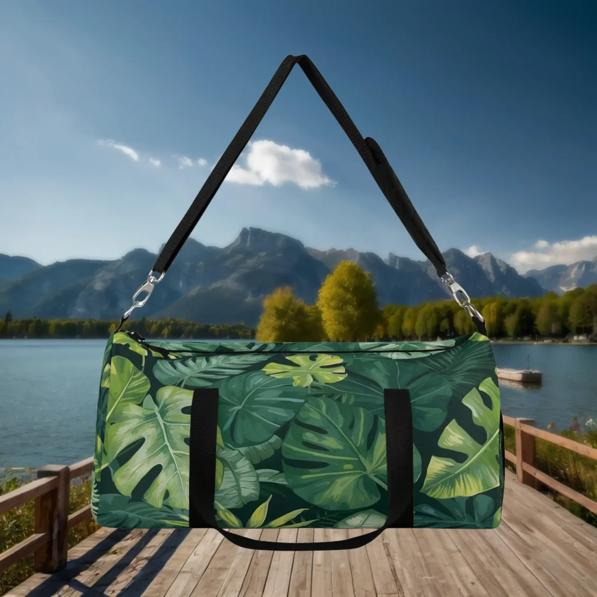 Front view of large duffel bag with green monstera and palm leaf print.
