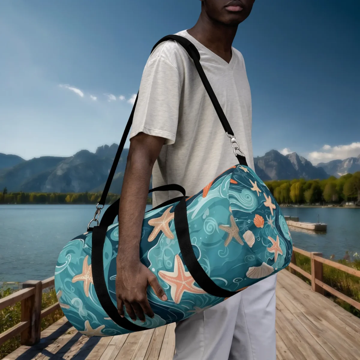 Man carrying a large duffel bag with whimsical ocean wave design and seashells.