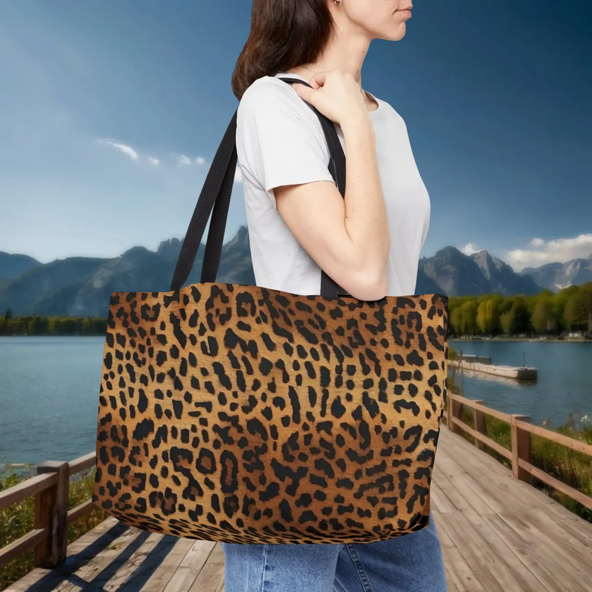 Woman carrying a weekender tote bag with brown and black leopard print