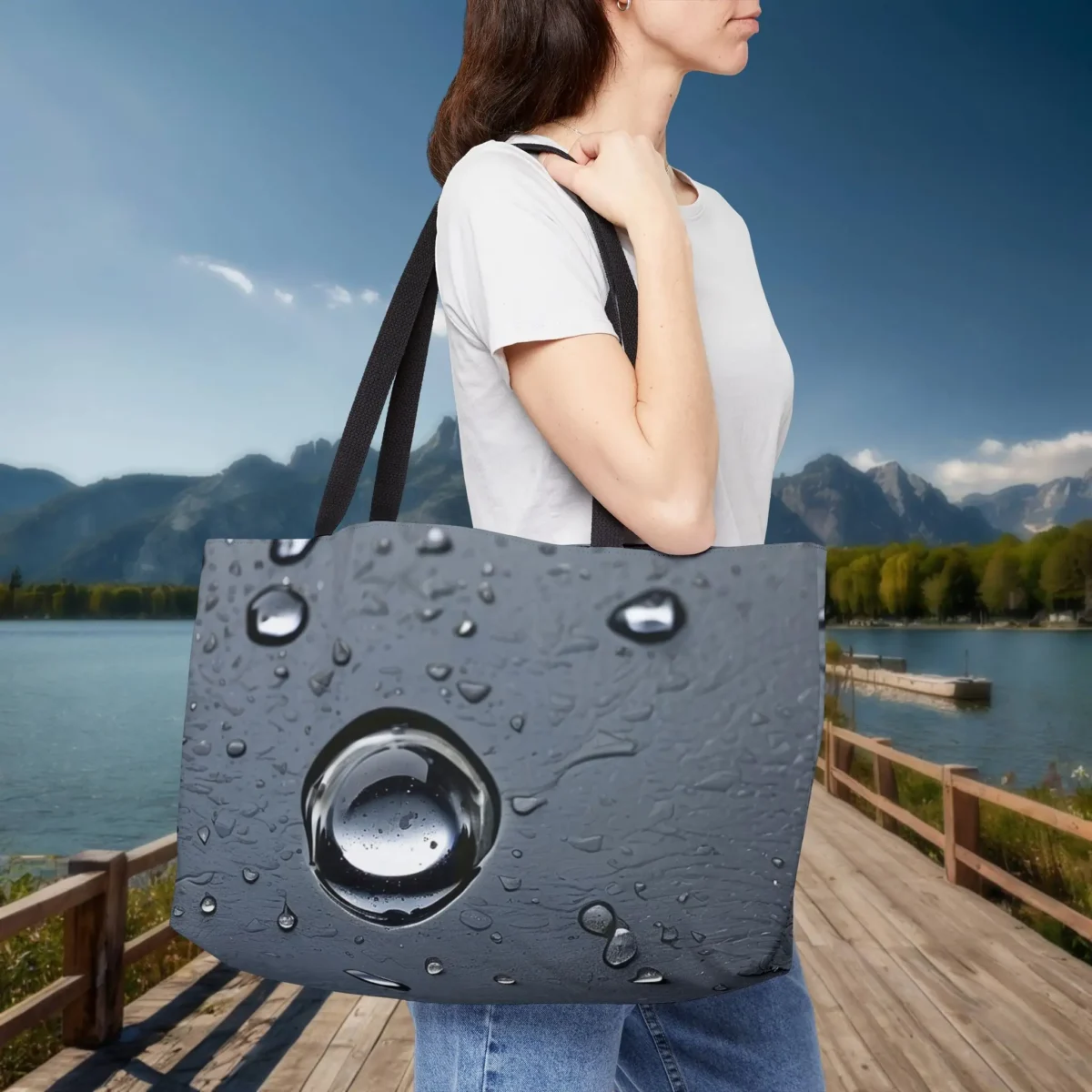 Woman carrying a weekender tote bag with realistic raindrop pattern on dark background