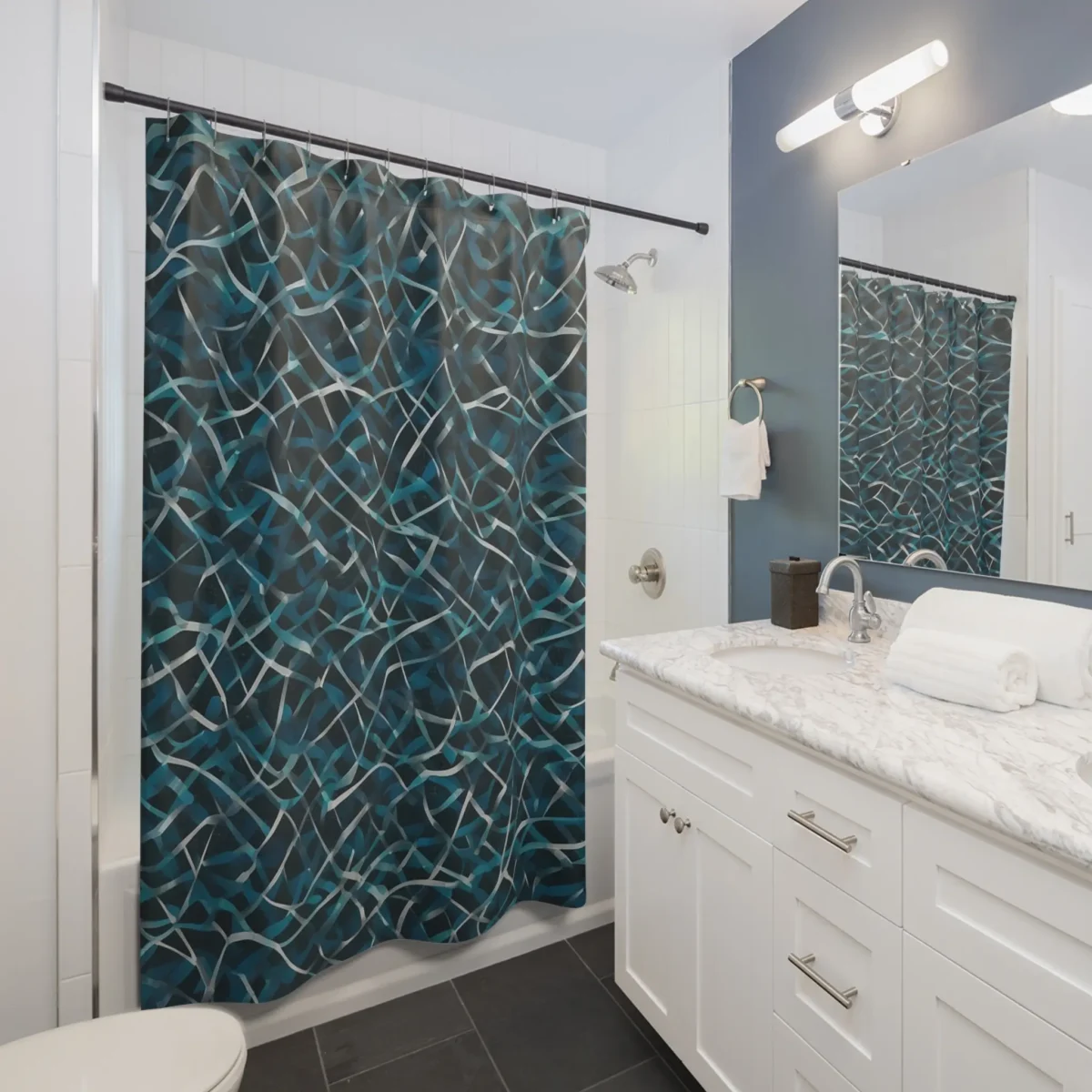 Shower curtain with abstract overlapping rhombus pattern in blue and grey tones in bathroom