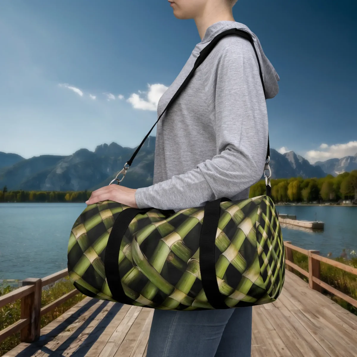 Person wearing a small duffel bag with woven bamboo stalk pattern in natural green tones.