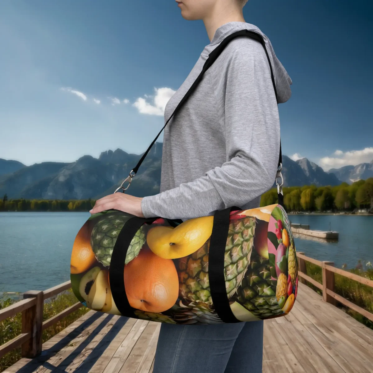 Woman carrying a small duffel bag with realistic tropical fruits pattern on black background.