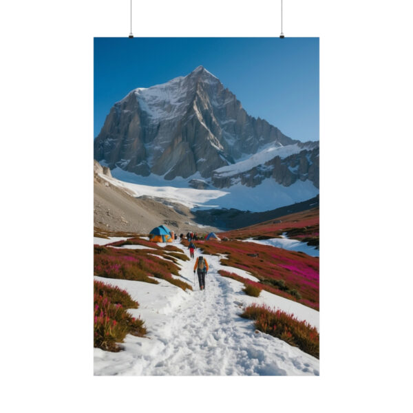 Hiker walking on a snowy path toward tents in a mountain landscape with blooming flowers