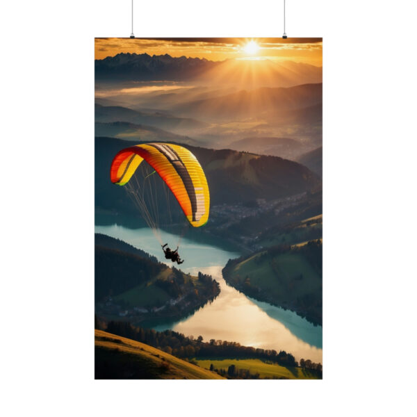 Paraglider flying above a river and valley at sunset with mountains in the distance