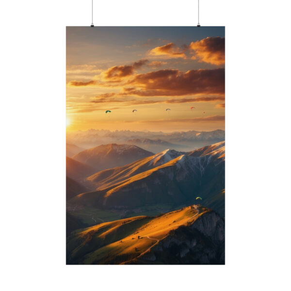 Paragliders flying over mountain peaks at sunset with golden light