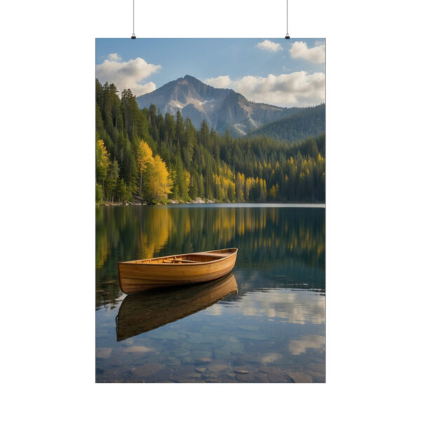 wooden canoe floating on a calm lake with reflection of autumn trees and mountains