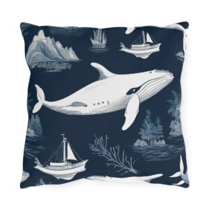 Outdoor pillow featuring a nautical design with whales, ships, and ocean scenes on a dark blue background