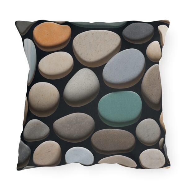 outdoor pillow featuring a pattern of smooth, multicolored pebbles with various textures on a black background