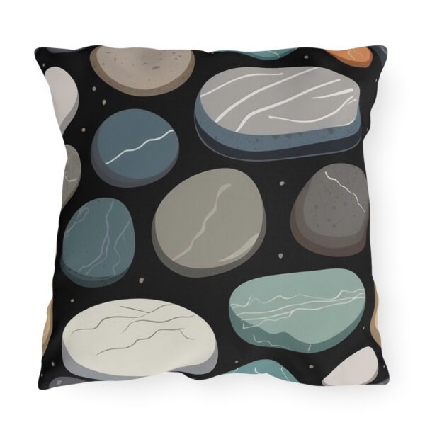 outdoor pillow featuring a pattern of smooth, multicolored stones with various textures on a black background