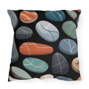 outdoor pillow featuring a pattern of colorful smooth stones with various textures on a black background