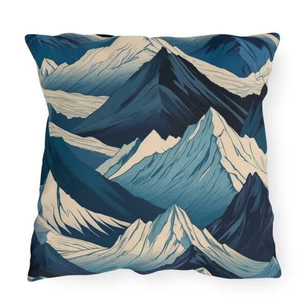 outdoor pillow featuring an abstract design of snow-capped mountain peaks in shades of blue and white