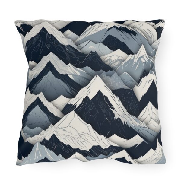 outdoor pillow featuring an abstract design of mountain peaks in shades of dark blue, gray, and white