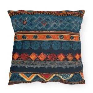 Outdoor pillow with intricate cultural patterns and textiles in vibrant colors on a dark background.