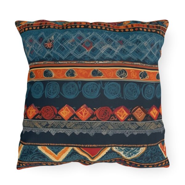 Outdoor pillow with intricate cultural patterns and textiles in vibrant colors on a dark background.