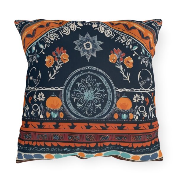 Outdoor pillow with vibrant cultural patterns and textiles on a dark background.