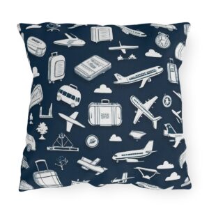 Outdoor pillow with travel icons like airplanes, trains, and luggage on a navy blue background.