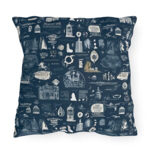 Outdoor pillow with white travel quotes and sketches on navy blue background