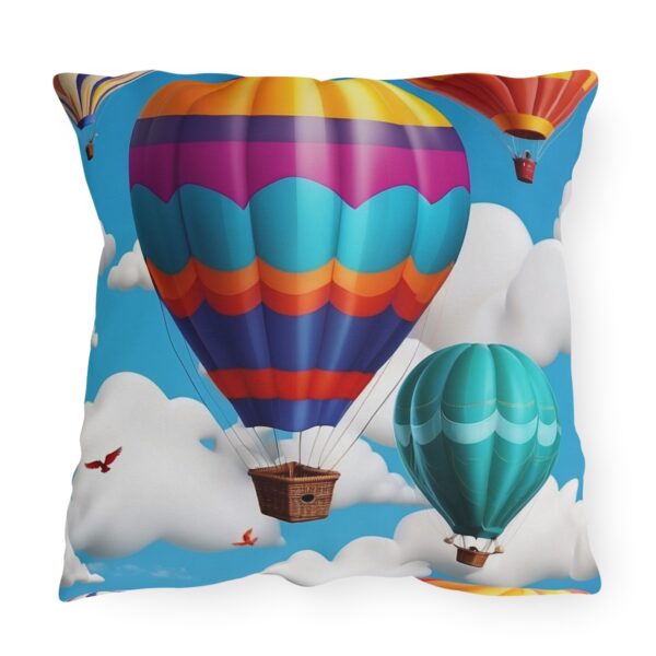 Outdoor pillow with vibrant hot air balloons design in blue sky