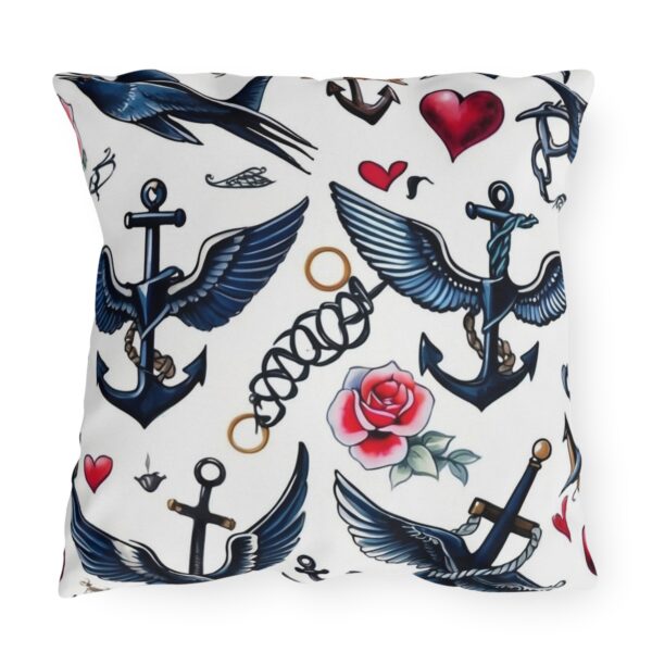 Outdoor pillow with white background featuring blue anchors, wings, heart, and rose designs