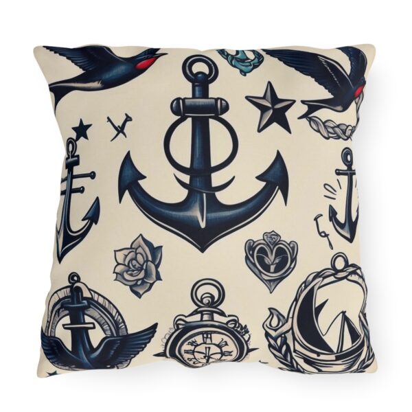 Outdoor pillow with beige background and black nautical anchor, bird, and maritime symbols design