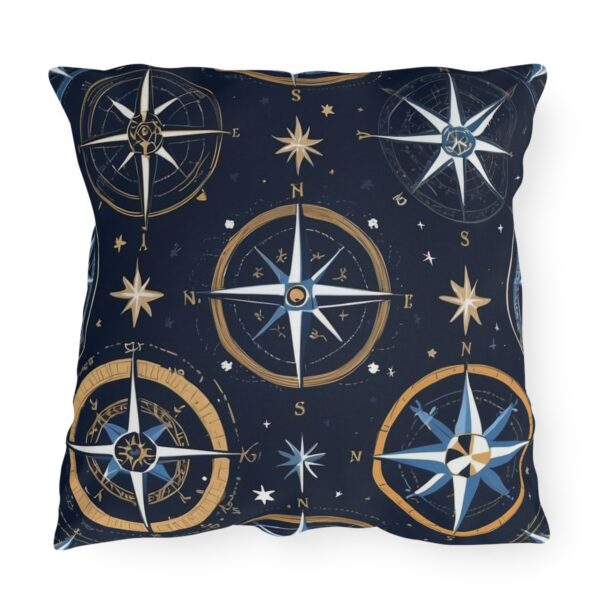 Outdoor pillow with navy blue background and gold and white nautical compass design