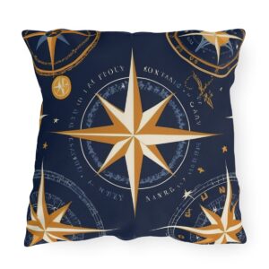 outdoor pillow featuring gold and white compass designs on a dark blue background