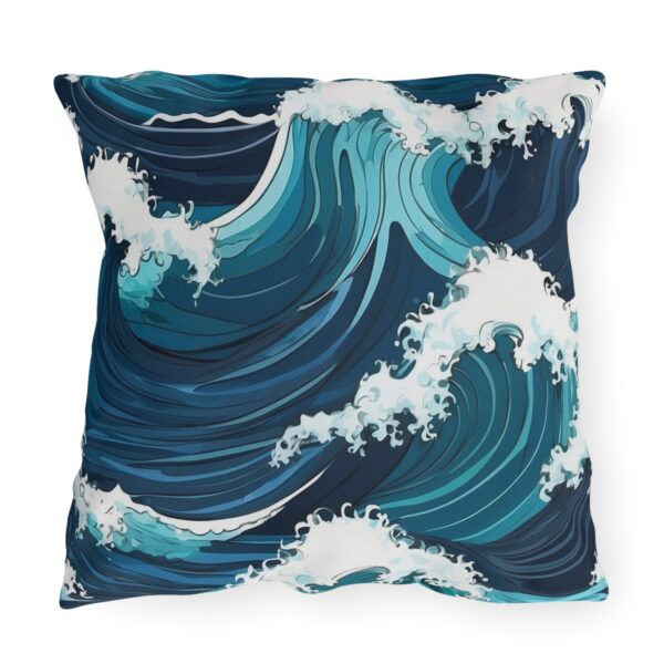 outdoor pillow featuring large crashing ocean waves in blue and white tones