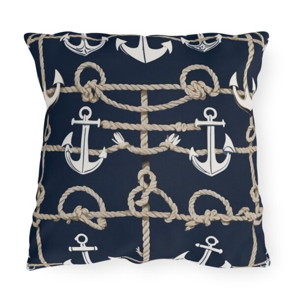 outdoor pillow featuring white anchors and beige ropes on a navy blue background