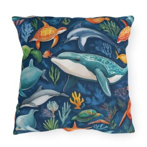 outdoor pillow featuring dolphins, turtles, and colorful sea creatures on a dark blue ocean background