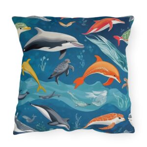 outdoor pillow featuring colorful dolphins, turtles, and other sea creatures on a deep blue ocean background