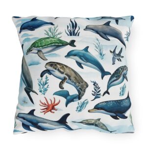 outdoor pillow featuring dolphins, turtles, and sea creatures on a light ocean background