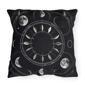 outdoor pillow with moon phases and leaf design on a black background