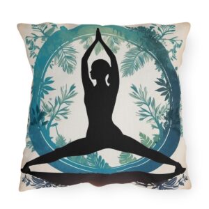 outdoor pillow with black silhouette of woman in yoga pose surrounded by blue and green leafy design